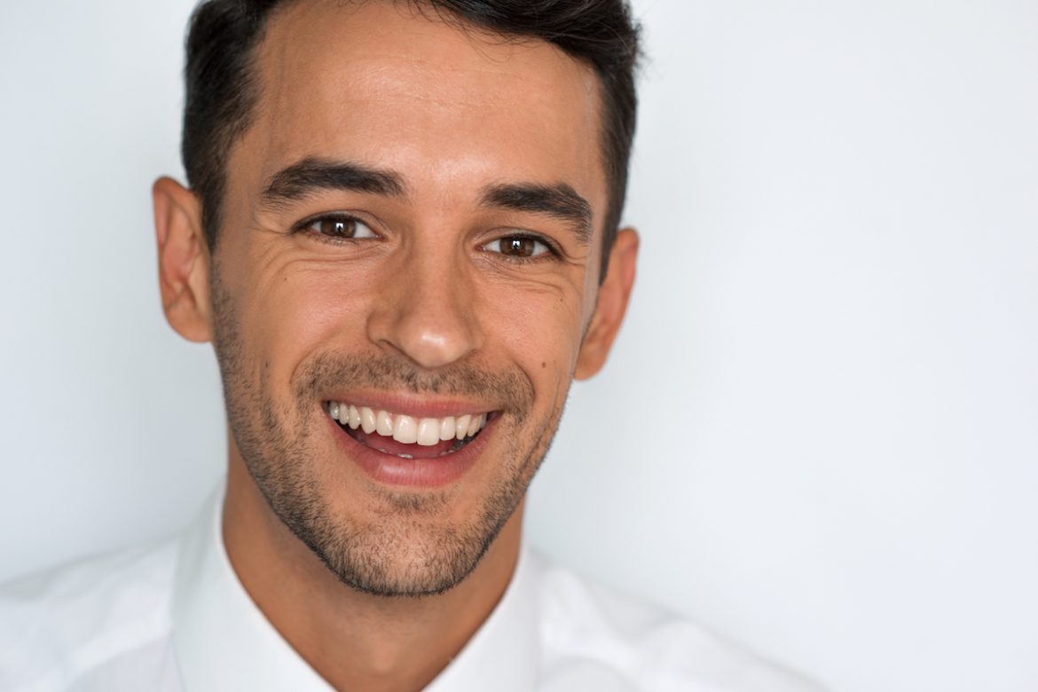 man in whitte shirt smiling