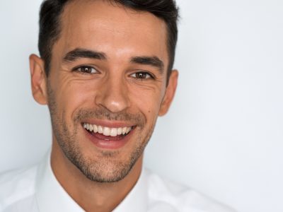 man in whitte shirt smiling
