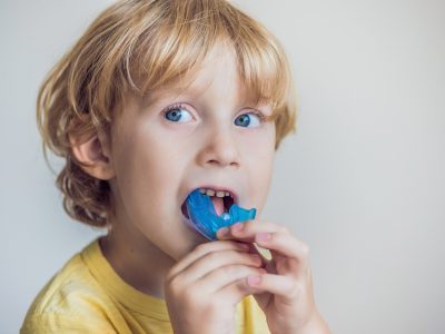 young boy putting in a mouthguard