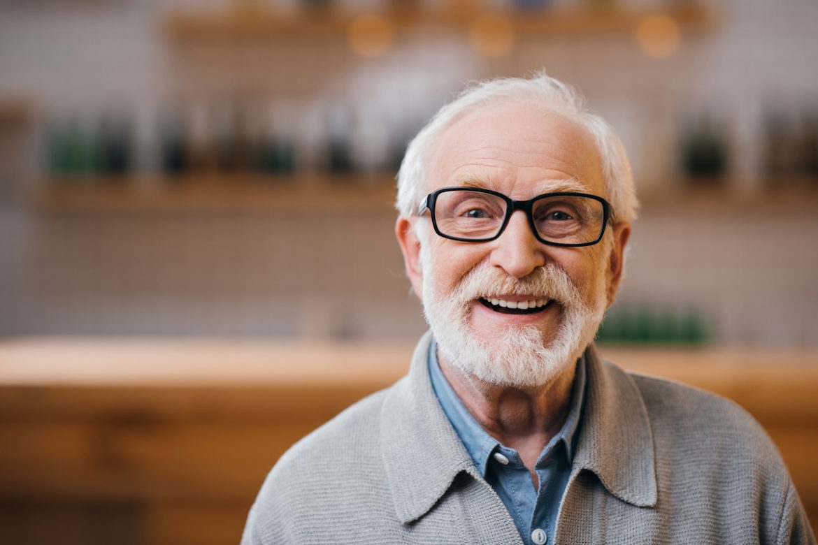older mn with white hair and beard smiling