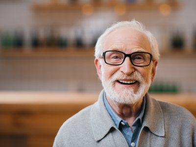 older mn with white hair and beard smiling